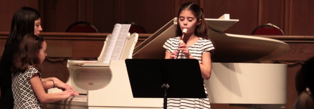 Sisters Performing on Piano and Recorder